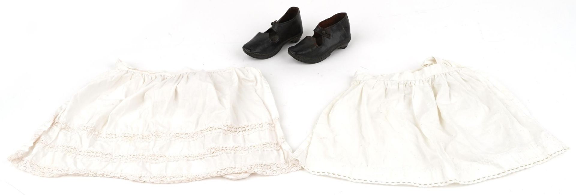Pair of Victorian leather child's shoes and two aprons