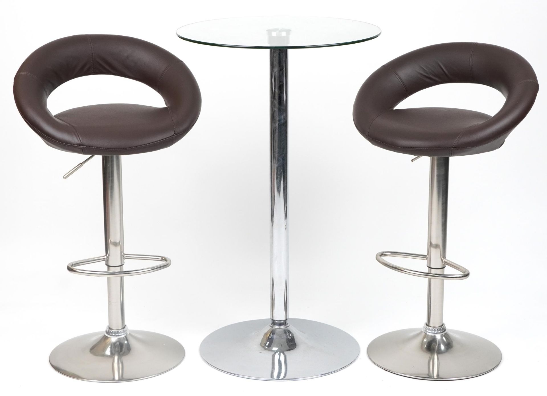 Contemporary chrome breakfast table with circular glass top and pair of adjustable stools with brown