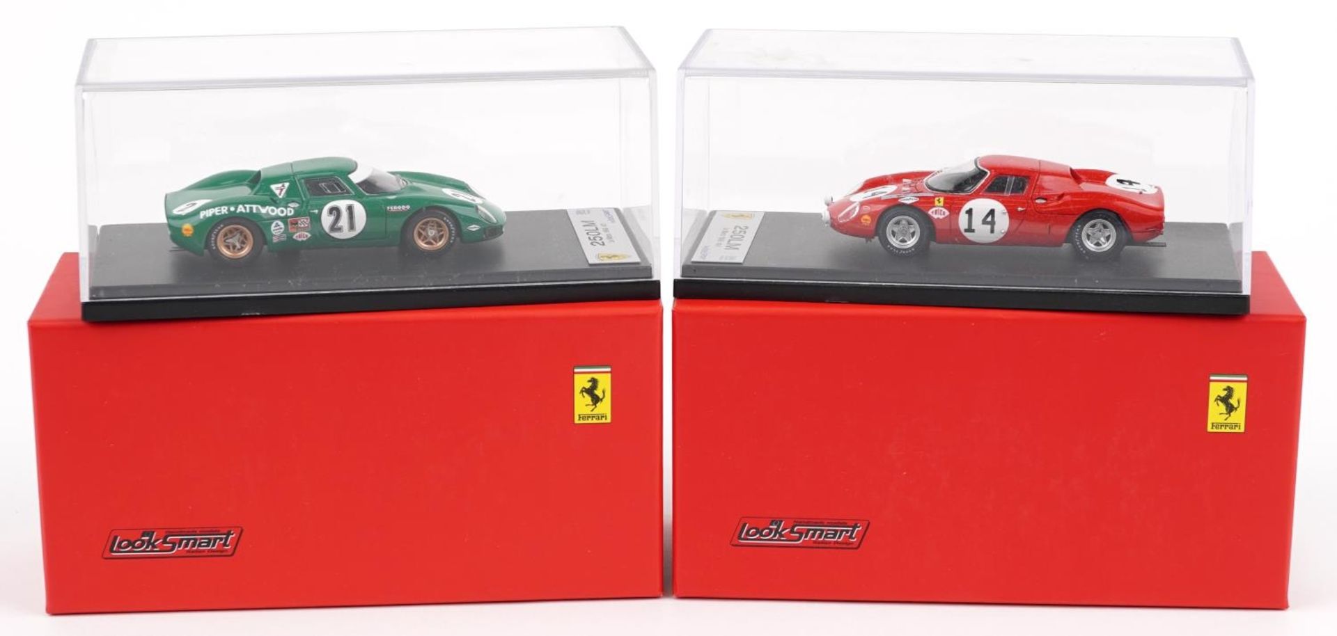 Two Looksmart 1:43 scale diecast model racing vehicles with boxes and display cases comprising Le