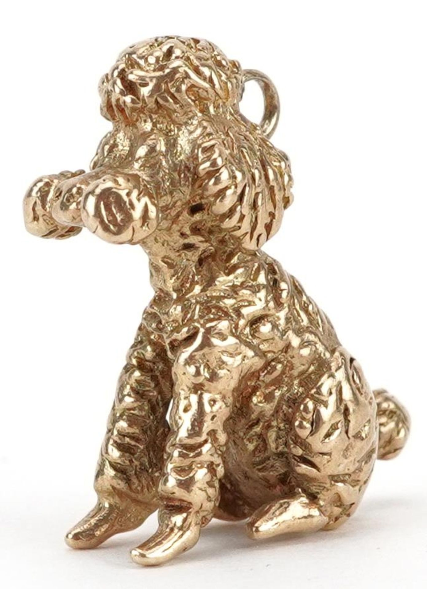 9ct gold charm in the form of a seated poodle, 2cm high, 6.8g