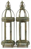 Pair of bronzed hanging lanterns with glass panels, each 79cm high