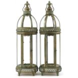 Pair of bronzed hanging lanterns with glass panels, each 79cm high