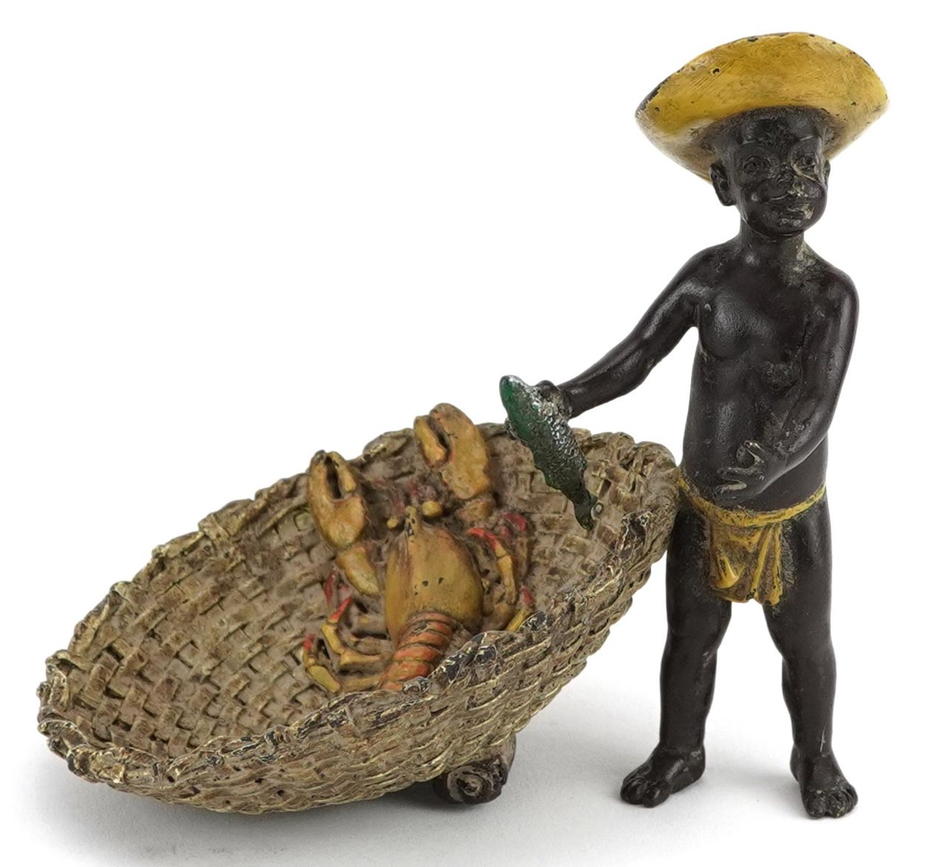 Austrian style cold painted bronze model of a boy holding a fish beside a basket with lobster,