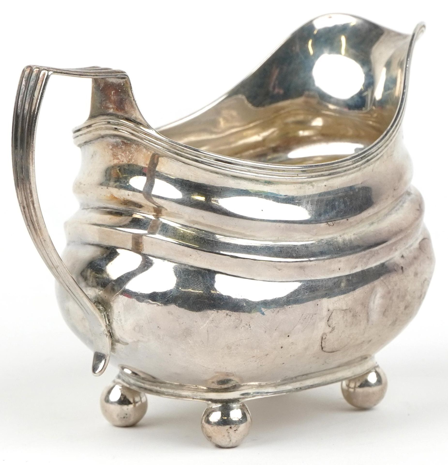 George III silver cream jug with four ball feet, indistinct maker's mark London 1819, 13cm in - Image 2 of 4