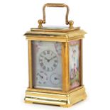 Miniature brass cased carriage clock with swing handle and Sevres style panels hand painted with
