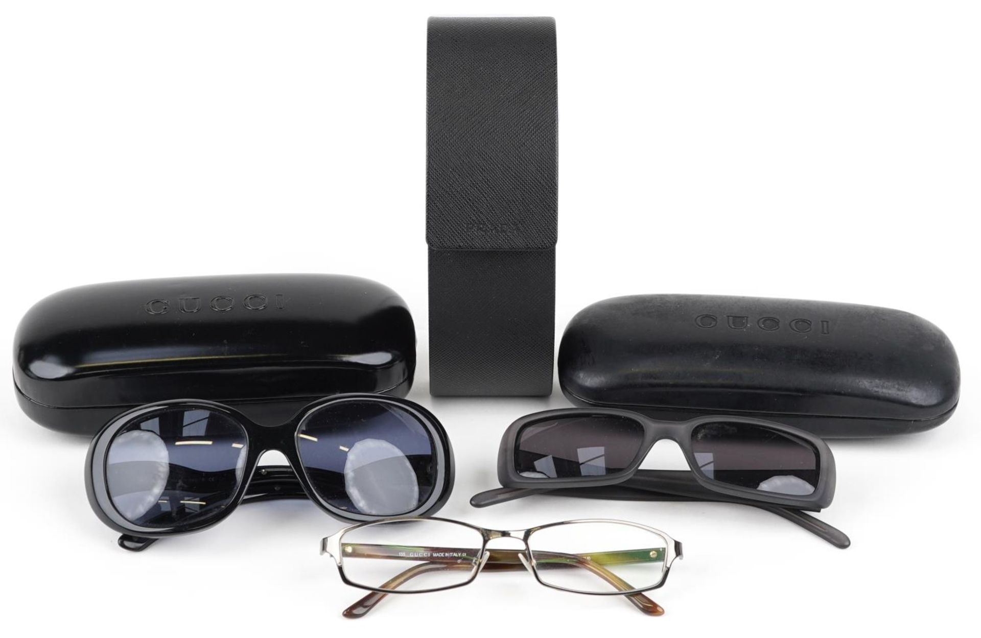 Three pairs of ladies sunglasses with cases comprising two Gucci and Prada