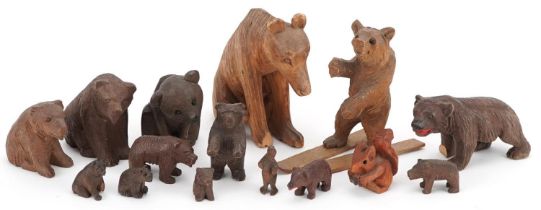 Fourteen German Black Forest carved wood bears and a squirrel, the largest 8cm high