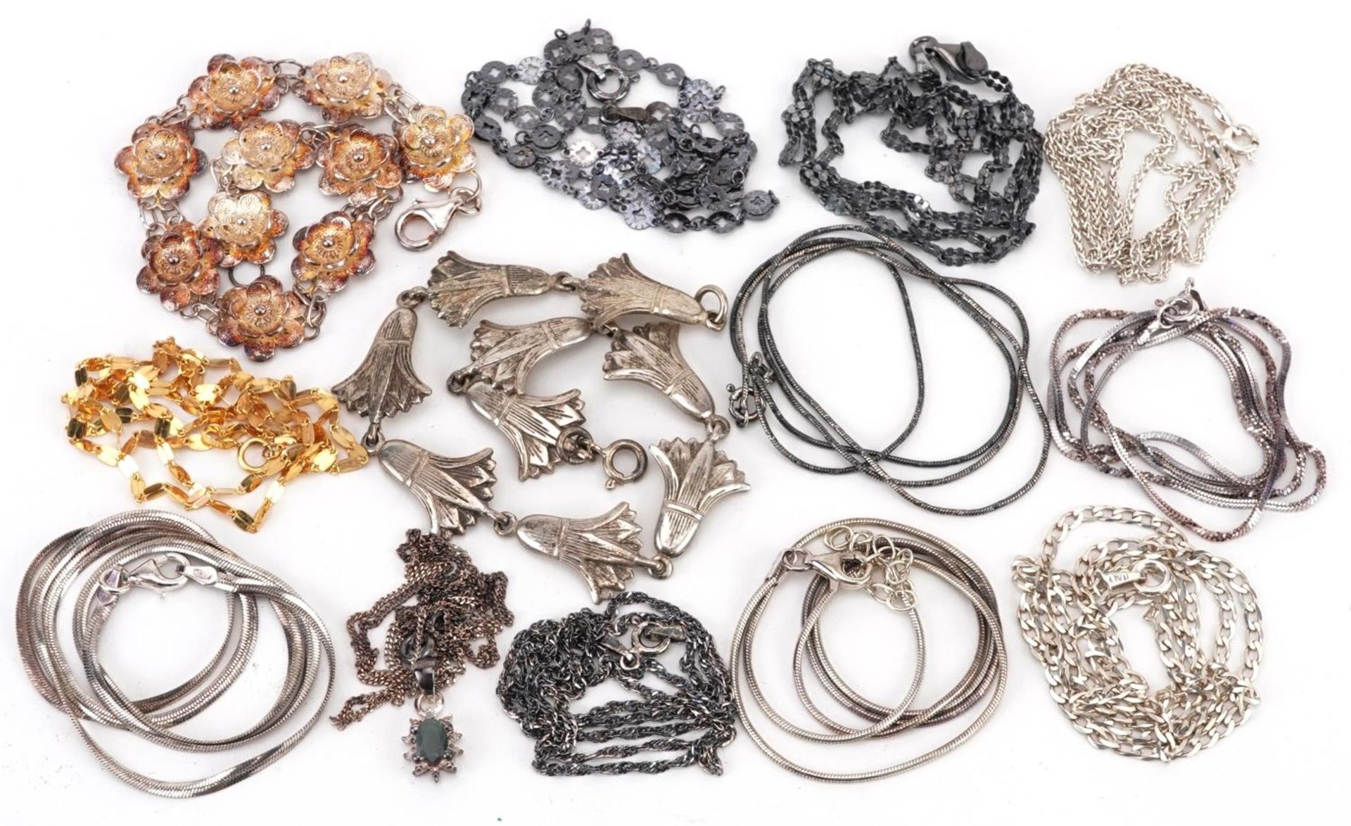 Silver jewellery comprising eleven necklaces and two floral bracelets, 55.0g
