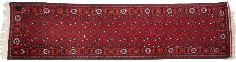 Rectangular Bokhara red ground carpet runner, 300cm x 82cm