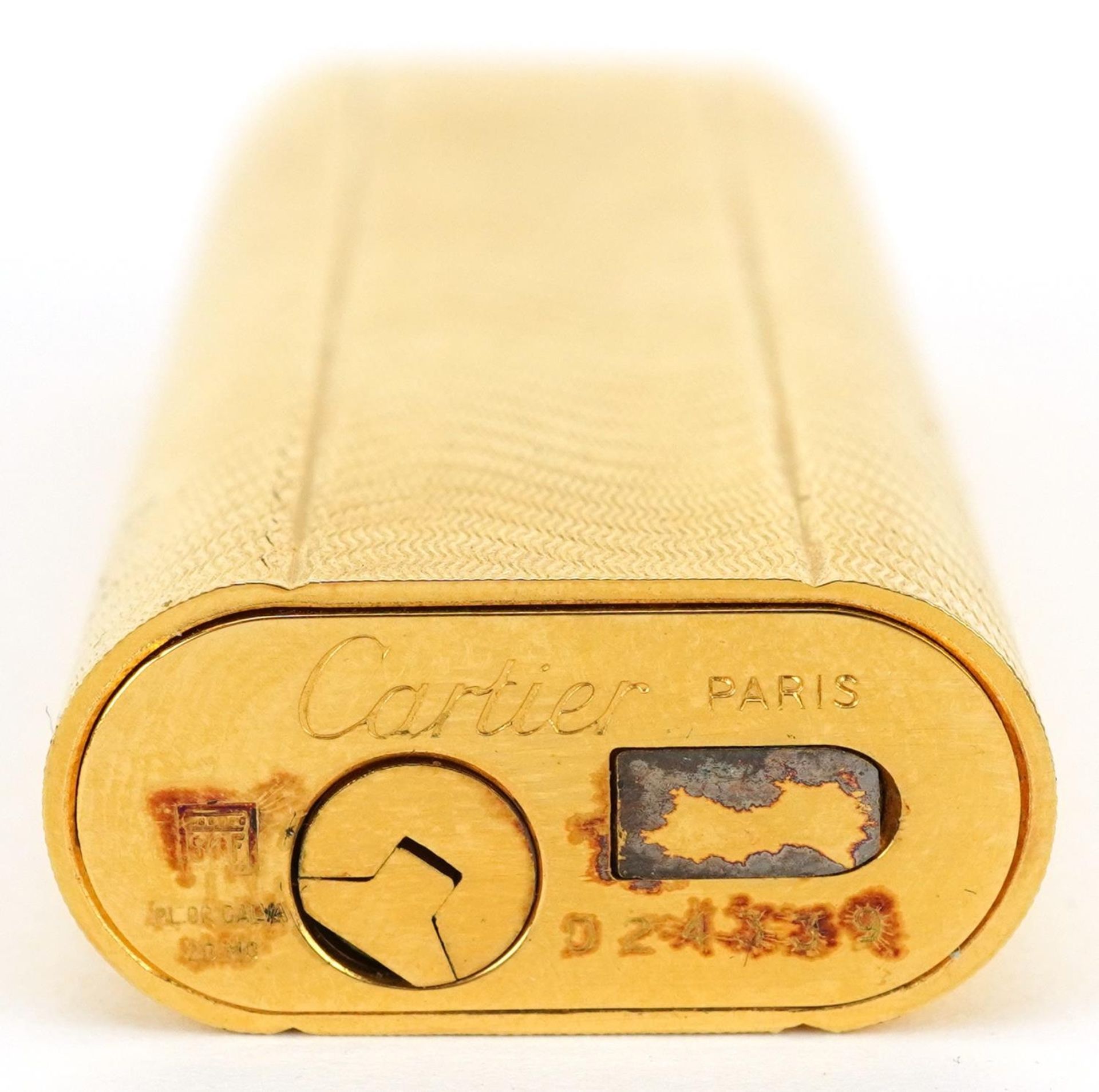 Cartier, gold plated French engine turned pocket lighter with box numbered D24339, 7cm high - Image 4 of 4