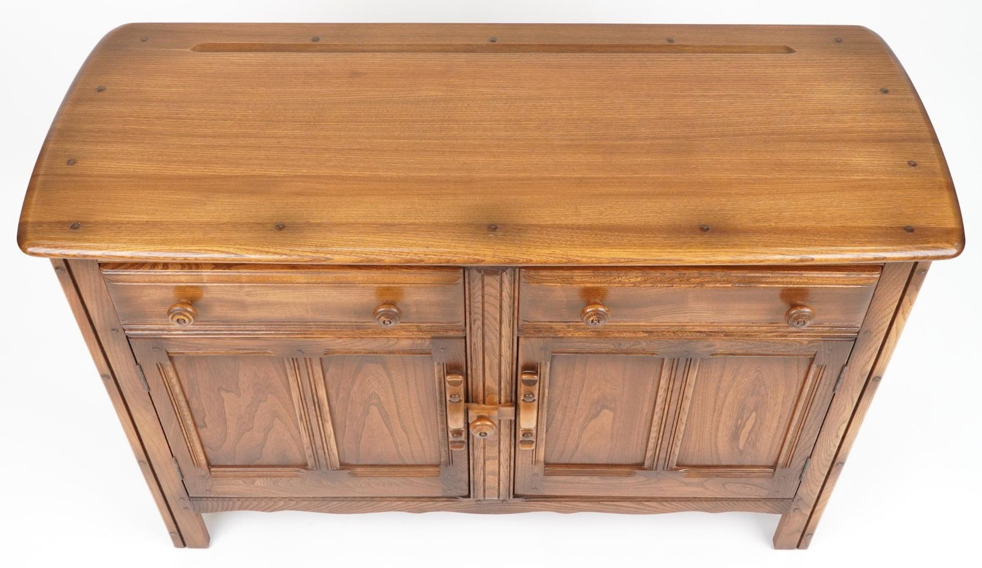 Ercol elm sideboard fitted with two drawers above a pair of cupboard doors, 85cm H x 122cm W x - Image 3 of 6