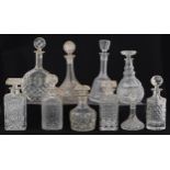 Nine glass decanters including a ship and Bohemian examples, the largest 30cm high