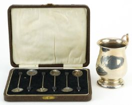 George V silver christening tankard and a set of six silver coffee bean spoons housed in a fitted