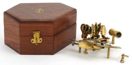 Shipping interest brass sextant housed in a hardwood case, the sextant 13cm in length