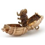 9ct gold charm in the form of a beer barrel opening to reveal two hinged elephants, 1.9cm wide, 6.8g