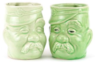 Pair of military interest green glazed mugs in the form of Bruce Bairnsfather's Old Bill, each 11.