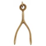 9ct gold charm in the form of a wishbone, 2.9cm high, 2.5g