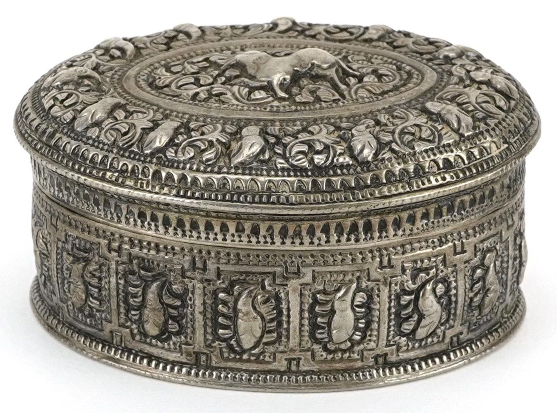 Anglo Indian white metal box and cover profusely embossed and engraved with wild animals and
