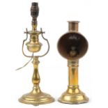Two antique brass lamps comprising a candle lamp by Veritas Lamp Works and a shipping interest