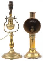 Two antique brass lamps comprising a candle lamp by Veritas Lamp Works and a shipping interest