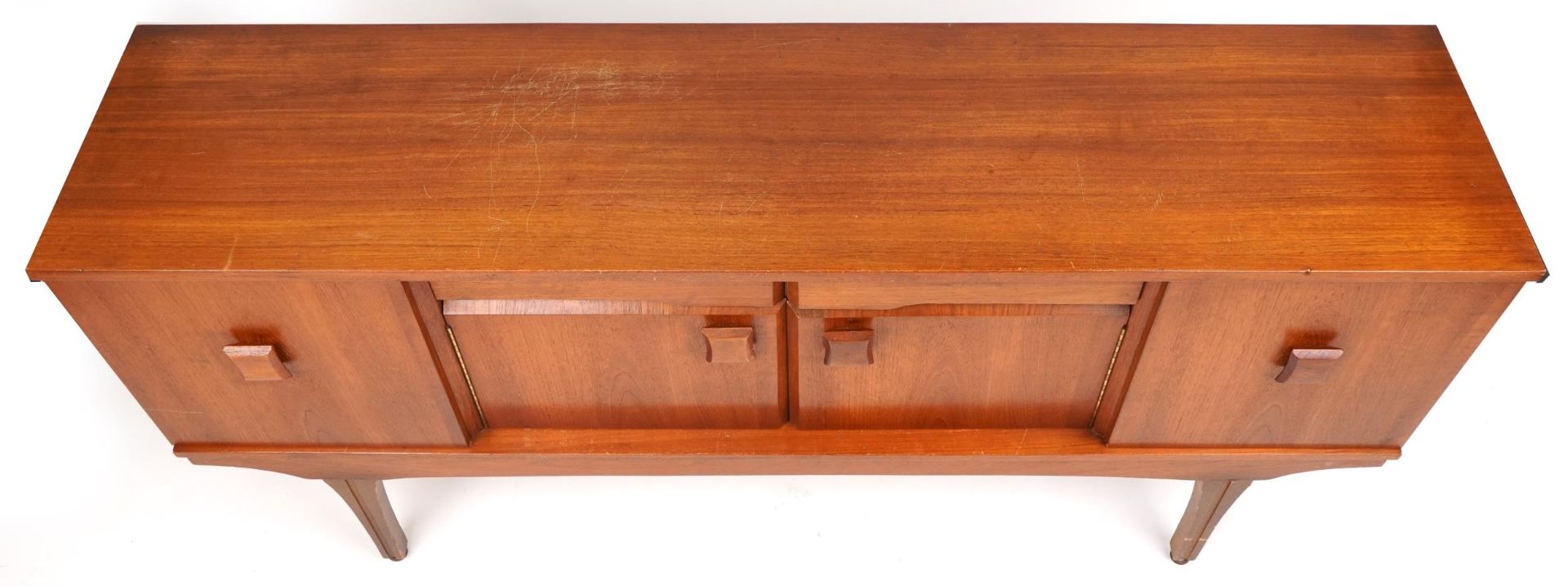 Mid century teak sideboard fitted with an arrangement of two drawers and four cupboard doors, 76cm H - Image 2 of 4