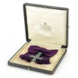 Military interest George V silver MBE awarded to Mrs E V Holford housed in a tooled leather silk and