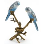 European patinated bronze and porcelain candle holder in the form of two budgies on a branch with