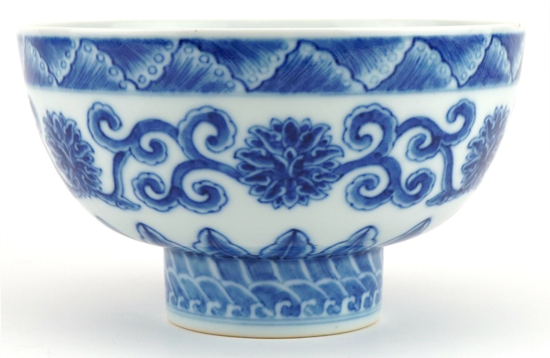 Chinese blue and white porcelain footed bowl hand painted with flower heads amongst scrolling