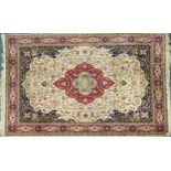 Rectangular Persian cream and red ground rug having an all over repeat floral design, 370cm x 270cm