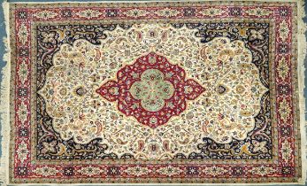 Rectangular Persian cream and red ground rug having an all over repeat floral design, 370cm x 270cm