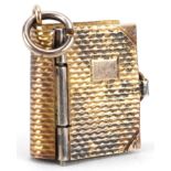 9ct gold charm in the form of a book with London postcards, 1.5cm high, 2.3g