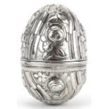 Unmarked silver trinket box in the form of an egg embossed with flowers and foliage, 5cm high, 15.4g