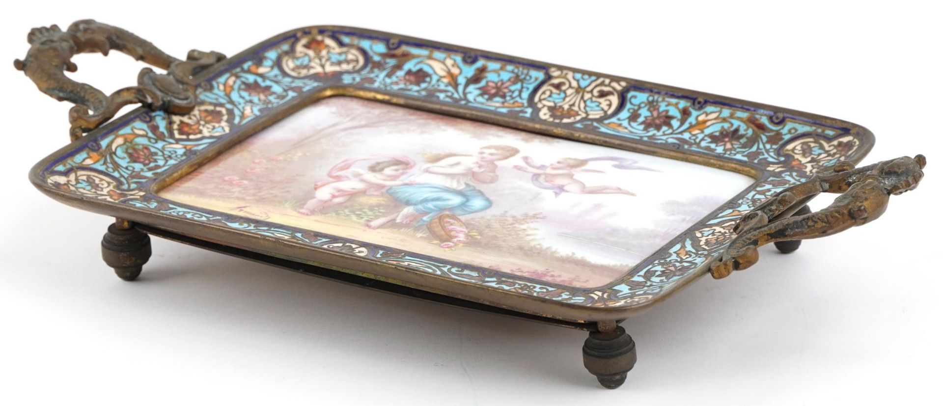 19th century French brass and champleve enamel four footed tray with twin dolphin handles inset with