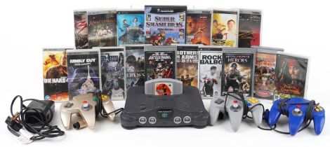 Nintendo 64 games console with controllers and a collection of Sony PSP games and movies