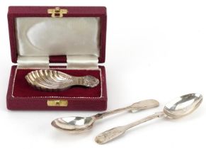 Three silver spoons including a silver shell shaped caddy spoon by Francis Howard with fitted