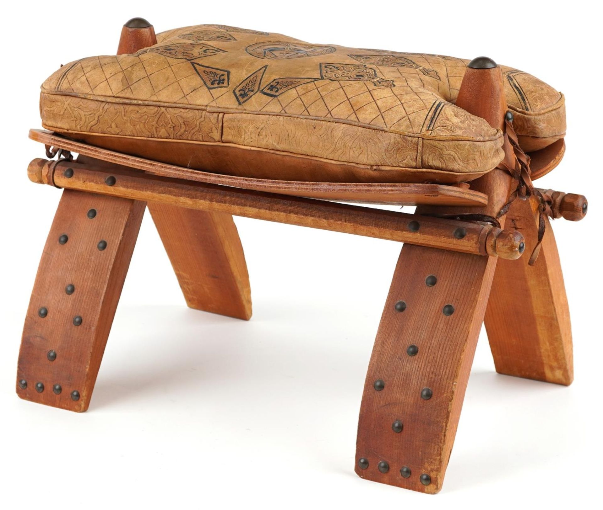 Vintage hardwood camel stool with leather upholstered cushion tooled with foliate motifs and a