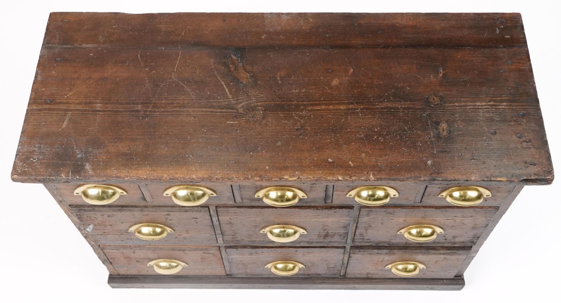 Stained pine haberdashery chest fitted with an arrangement of eleven drawers having brass handles, - Image 3 of 4