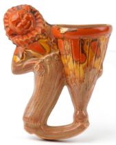 Clarice Cliff, Art Deco pottery wall pocket in the form of a clown hugging a vase, 19cm high