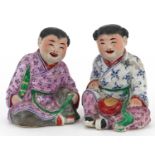 Pair of Chinese porcelain figures of children wearing robes, the largest 9.5cm high