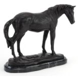 Patinated bronze study of a horse raised on a black marble base, 25cm in length