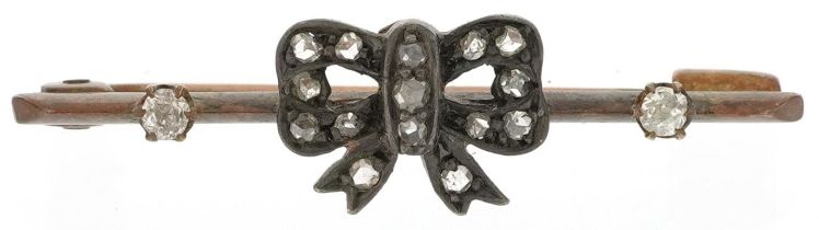 Antique unmarked gold diamond bar brooch in the form of a bow housed in a velvet and silk lined