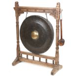 Large Antique Tibetan patinated bronze monastery gong on later oak stand, overall 121cm high x 100cm