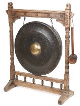 Large Antique Tibetan patinated bronze monastery gong on later oak stand, overall 121cm high x 100cm