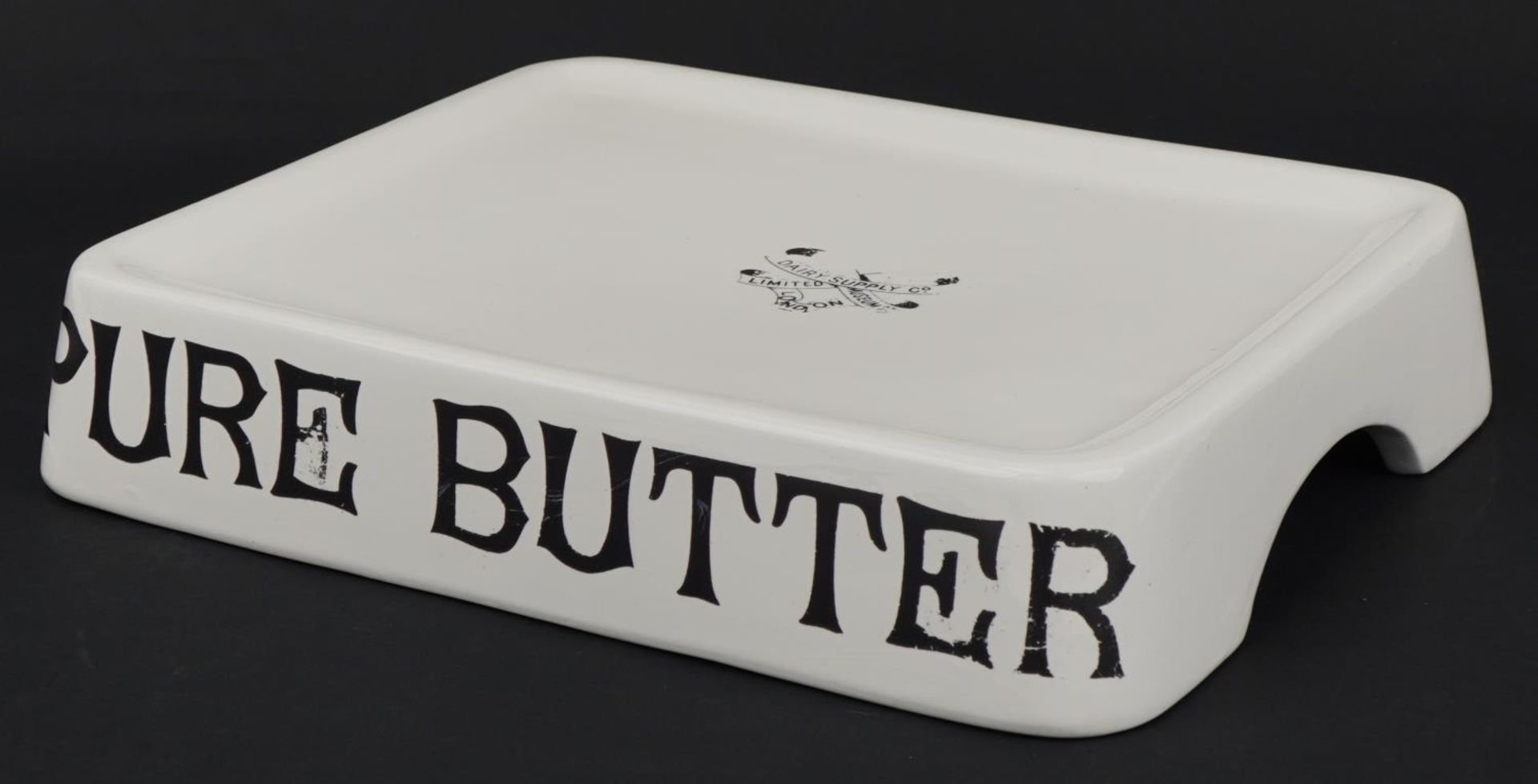 Agricultural interest Pure Butter ceramic stand, 34cm wide