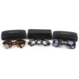 Three pairs of ladies sunglasses with cases housed in Versace cases comprising two Versace and