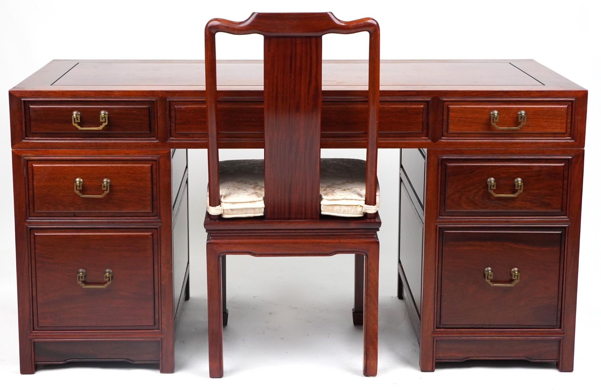 Chinese rosewood twin pedestal desk fitted with an arrangement of seven drawers, with matching
