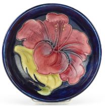 Moorcroft footed bowl hand painted in the hibiscus pattern, 11.5cm in diameter