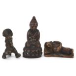 Three Chinese and Asian patinated bronze figures including an example of seated Buddha, the