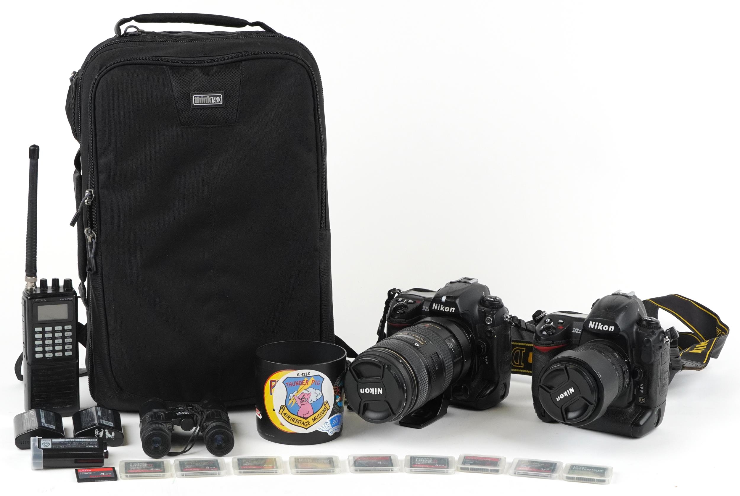Two Nikon cameras with accessories comprising Nikon D3X with 80-105mm DX lens and Nikon D2X with