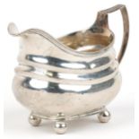 George III silver cream jug with four ball feet, indistinct maker's mark London 1819, 13cm in